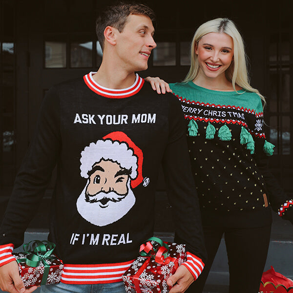 image of man and woman wearing ugly christmas sweaters