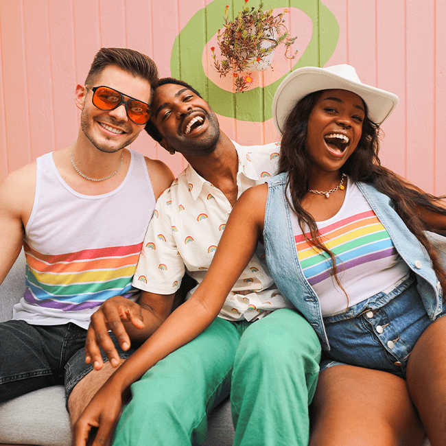 shop pride - models wearing white rainbow all the way racerback tank top, white rainbow all the way tank top, and white rainbow button down shirt