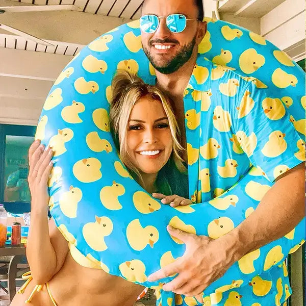 image of customer wearing our men's rubber ducky hawaiian shirt and holding our rubber ducky pool float