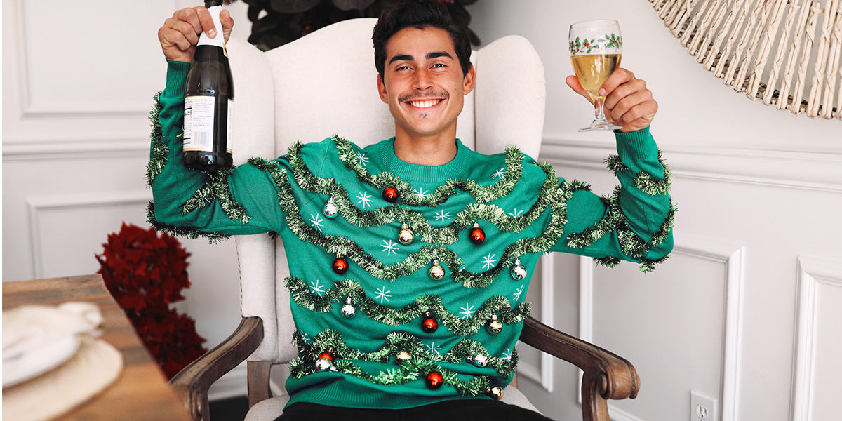 image of model wearing men's gaudy garland ugly christmas sweater
