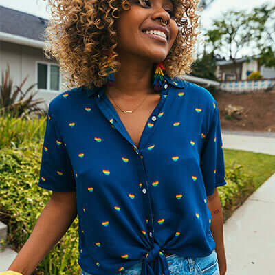 shop button down shirts - Model wearing rainbow hearts tie-front shirt