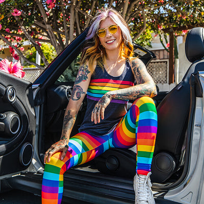 shop pride & lgbtq+ - image of model wearing rainbow leggings and charcoal rainbow all the way racerback tank top 