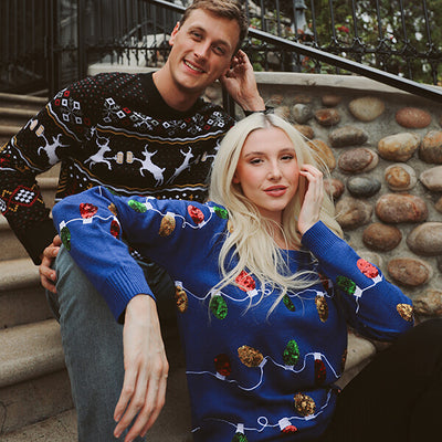 shop christmas - models wearing men's caribrew ugly christmas sweater and women's Christmas lights ugly christmas sweater