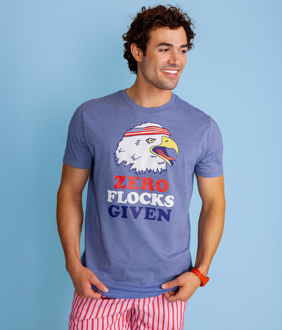 Man wearing a blue t-shirt with an eagle graphic and text against a light blue background