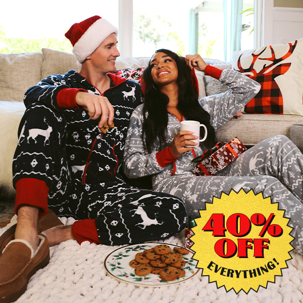 shop onesies - mens blue reindeer jumpsuit and women's grey moose jumpsuit