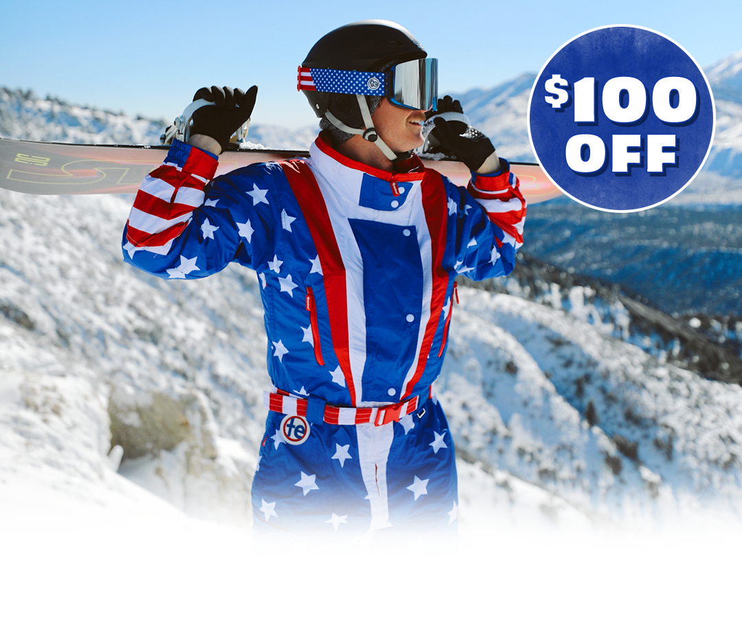 shop mens snow suits - image of man wearing a snow suit and holding a snowboard
