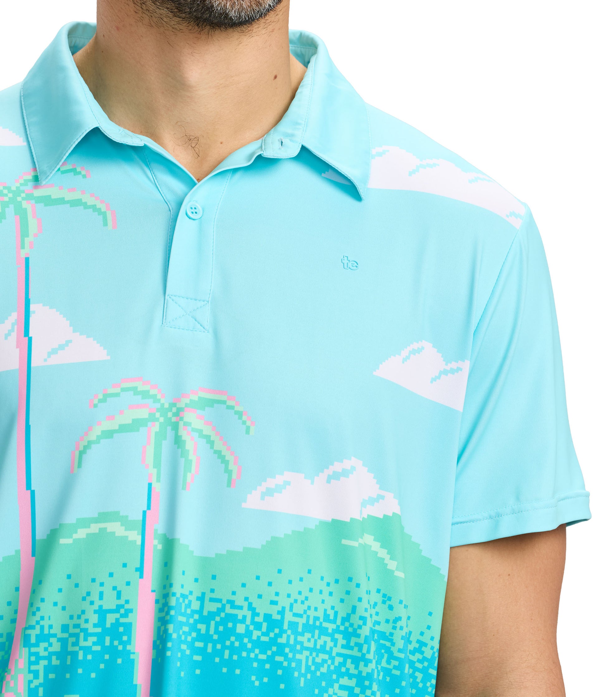 Light blue polo shirt with palm tree and cloud pattern on a white background
