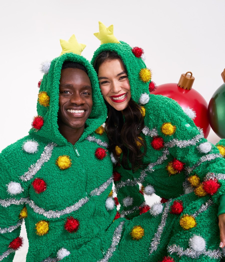 Couple in matching Christmas tree onesies