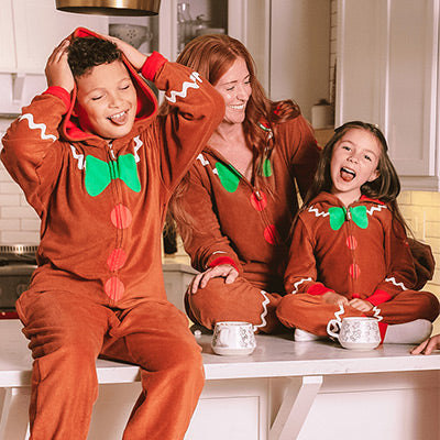 shop all - image of a boy, girl, and woman wearing a gingerbread jumpsuit
