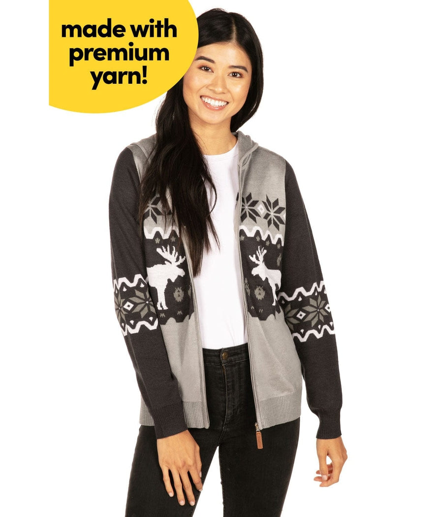 Woman wearing a black and gray patterned cardigan with text 'made with premium yarn' on a white background