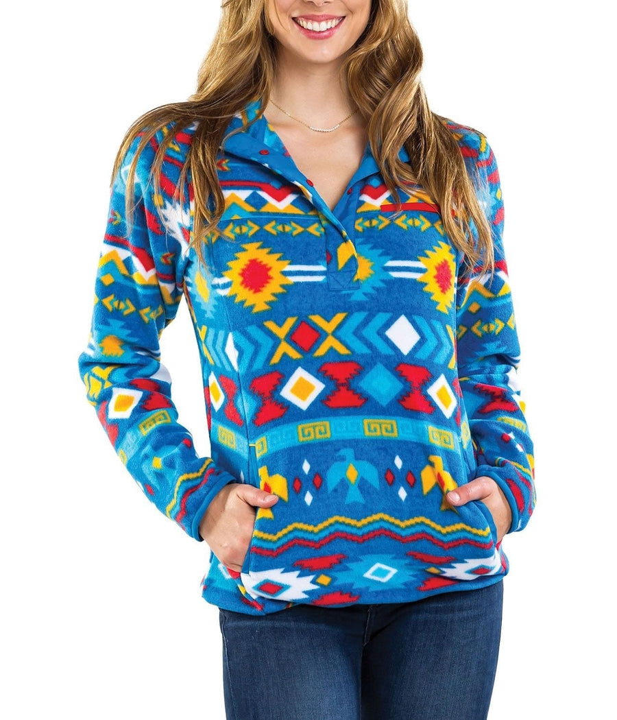 Woman wearing a colorful patterned pullover with a white background