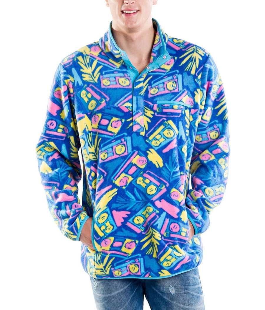 Person wearing a colorful jacket with a retro cassette tape pattern on a white background